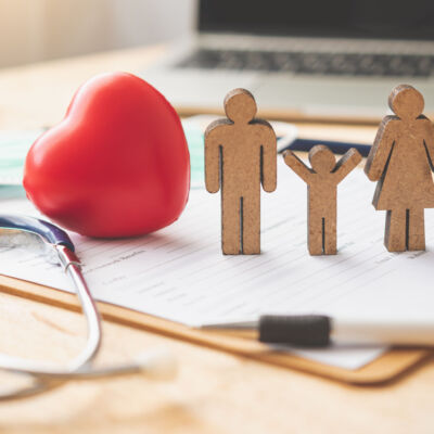 Medical Insurance Concept With Family And Stethoscope On Wooden
